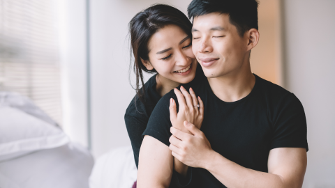 A couple embrace sweetly.